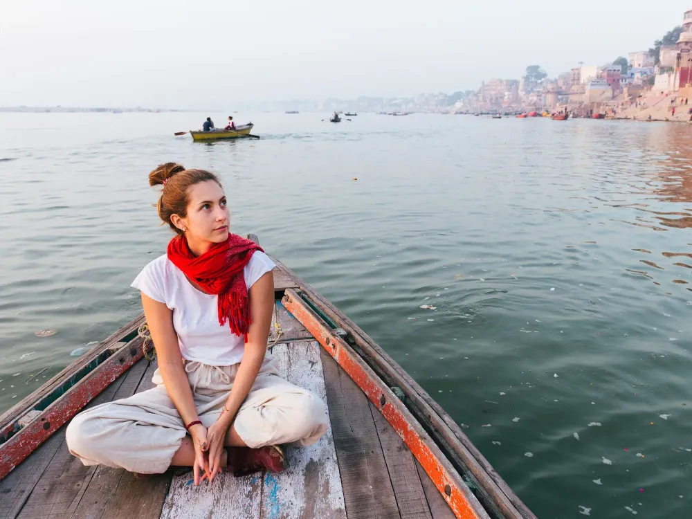 woman wearing scarf on a boat in the ganges river in India